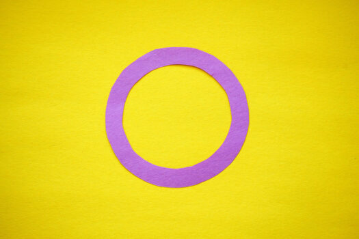 yellow background with pink circle symbolizing intersex